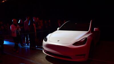 People view a model of the new Tesla Model Y. AFP