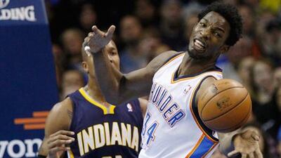 Oklahoma City Thunder's Hasheem Thabeet reaches for a loose ball ahead of Indiana's David West.
