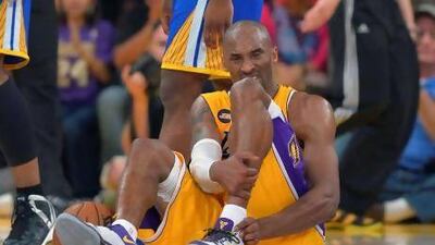 Los Angeles Lakers guard Kobe Bryant grimaces after being injured during the second half of the Lakers' game against the Golden State Warriors on Friday. Mark J. Terrill / AP Photo