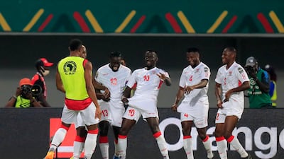 Musa Barrow celebrates with teammates after scoring Gambia's winning goal against Guinea. Reuters
