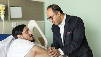 Marwan Al Suwaidi, pictured with Dr Ayman Soliman, has already lost 10kg since surgery and hopes to get his weight down to 80kg in the future. Christopher Pike / The National