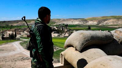 A fighter from the Manbij Military Council stands guard near the village of Awshariyah, north of Manbij on March 31, 2018. Delil Souleiman / AFP Photo