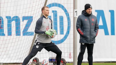 Bayern goalkeeper Manuel Neuer during training as manager Hansi Flick looks on. Getty