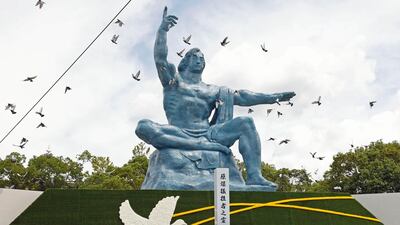 Doves fly over the Peace Statue during a ceremony to mark the 77th anniversary of the US atomic bombing in Nagasaki, southern Japan, in 2022. AP