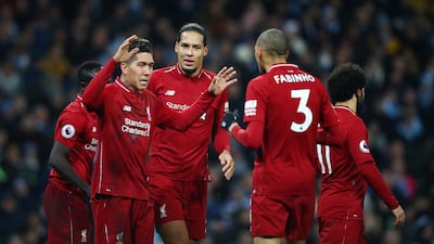 Roberto Firmino of Liverpool celebrates after scoring his team's first goal with his team mates. Getty Images