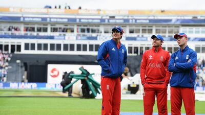 Cook, left, Ian Bell and Jonathan Trott stepped out to check the outfield with the rain having ceased again and with a lot of the water having been pumped out of the ground. Gareth Copley / Getty Images
