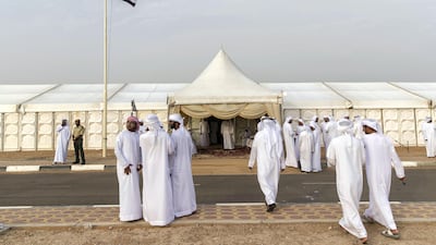 Men gather to pay their respects to the family of Captain Ahmed Khalifa Al Baloushi, 27, a UAE soldier who died in a helicopter crash while serving in Yemen, at a majlis outside the Al Towayya mosque in the Al Towayya area of Al Ain on August 13, 2017. Christopher Pike / The National