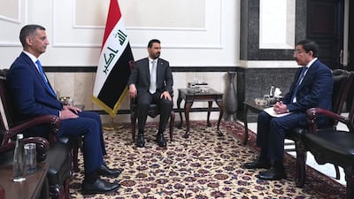 Iraq's new central bank governor Nazar Nasser Hussein, left, and former governor Ali Al Alaq, right, attend the official handover ceremony with Prime Minister Ali Al Zaidi, centre. Photo: Iraq Prime Minister's Office
