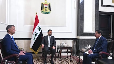 Iraq's new central bank governor Nazar Nasser Hussein, left, and former governor Ali Al Alaq, right, attend the official handover ceremony with Prime Minister Ali Al Zaidi, centre. Photo: Iraq Prime Minister's Office