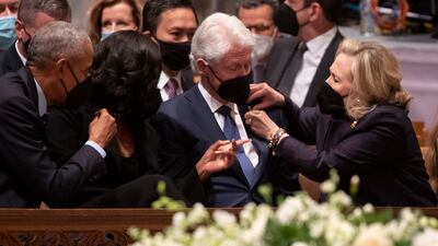 Barack and Michelle Obama chat to Bill and Hillary Clinton. EPA