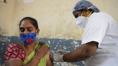 A health worker inoculates a woman with a dose of the Covishield vaccine against Covid-19 during a special vaccination programme at a government school in Hyderabad. AFP