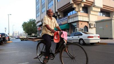 ABU DHABI - UNITED ARAB EMIRATES - 07 JUNE 2012 - Cartoon box collector goes around at Bur Hoaz area an old neighbourhood behind Al Wahda mall in Abu Dhabi. Ravindranath K / The National (FOR SUMMER SERIES)
