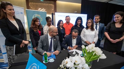 A pledge is signed as part of the UN Environmental Programme’s Recipe of Change campaign in Dubai. Ruel Pableo for The National