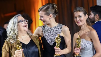 US filmmaker Carol Dysinger and director Elena Andreicheva, winners of the award for Best Short Subject Documentary for "Learning to Skateboard in a Warzone (If You're a Girl)", and Icelandic musician Hildur Gudnadottir (centre) winner of the award for Best Original Score for "Joker", at the Governors Ball after the Oscars on Sunday, February 9, 2020, at the Dolby Theatre in Los Angeles. AFP