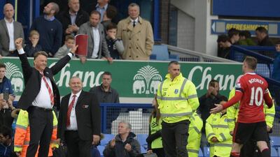 Manchester United's Louis van Gaal celebrates a goal along with Wayne Rooney on Saturday during their Premier League win over Everton. Oli Scarff / AFP / October 17, 2015