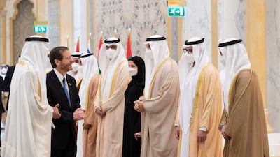 Isaac Herzog greets Mohamed Al Khaja, UAE Ambassador to Israel (L). Seen with Mohamed Al Mubarak, Khaldoon Al Mubarak, Sarah Al Amiri and other dignitaries. Mohamed Al Hammadi / Ministry of Presidential Affairs