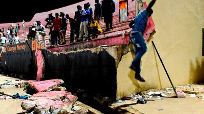 People look at the scene after a wall collapsed at Demba Diop stadium on July 15, 2017 in Dakar after a football game between local teams Ouakam and Stade de Mbour. AFP / Seyllou