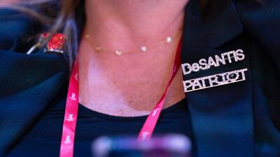 A woman attending the conference wears a De Santis pin in support of the Florida governor. AP