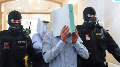 Austrian Beran A covers his face as he enters court before being sentenced to 15 years in jail. Reuters