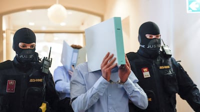 Austrian Beran A covers his face as he enters court before being sentenced to 15 years in jail. Reuters
