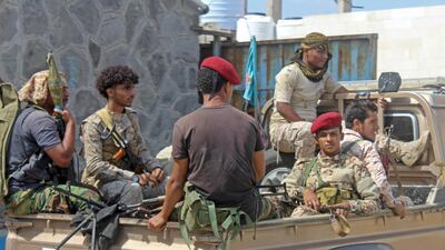 Yemeni military security personnel sit in the back of a pick up truck at the airport in the southern city of Aden on January 3, 2021. AFP