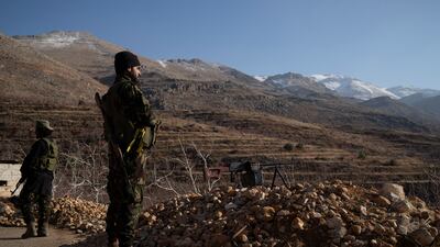 Members of Syria's new government-led security forces stand guard at a checkpoint near the border with Lebanon, in the Syrian town of Serghaya. AP