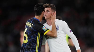 England's Mason Mount is embraced by Kosovo's Anel Raskaj after the match. Reuters