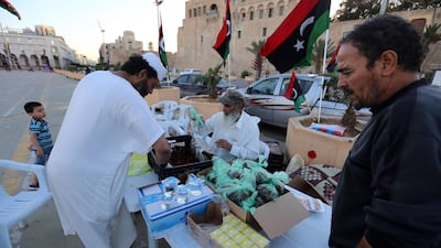 Libyans prepare to distribute snacks and water to people to break their fast near sunset during Ramadan in the Martyrs Square of the capital Tripoli. AFP