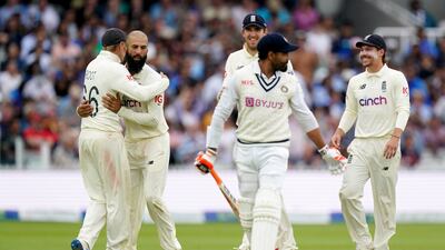 England's Moeen Ali and Joe Root celebrate after dismissing India's Ravindra Jadeja.