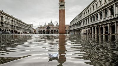 This photo from November this year shows a paper boat floating in a flooded St. Mark's Square in Venice. AP / Luca Bruno