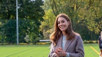 The Duchess of Cambridge is behind a spike in searches for 'checkered overcoats', seen here wearing a Massimo Dutti coat over a light blue jumper by the same brand to visit students at the University of Derby on October 6. Getty Images