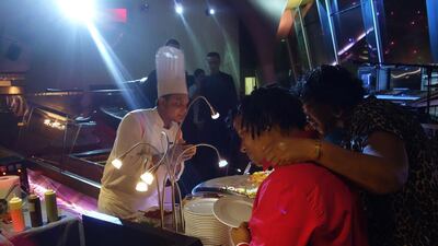 Visitors at the Yas Viceroy look over a sampling of food that will also be offered at the first Taste of Abu Dhabi. Delores Johnson / The National