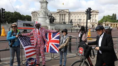 Royal fan Joseph Afrana holds flags with tourists from Taiwan near Buckingham Palace during U.S. President Donald Trump’s state visit to Britain in London, Britain, June 3, 2019. Reuters