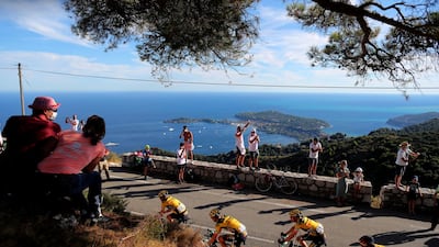 Spectators watch the riders pass through Eze near Nice during Stage 2. AP