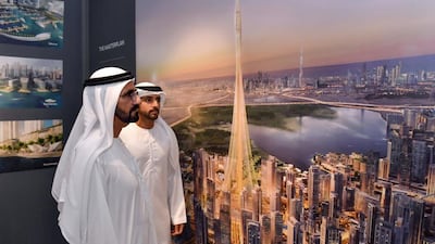 Sheikh Mohammed bin Rashid, the Vice President and Ruler of Dubai, and Sheikh Hamdan bin Mohammed bin Rashid, the Dubai Crown Prince, look at an illustration of the "The Tower at Dubai Creek Harbour". WAM