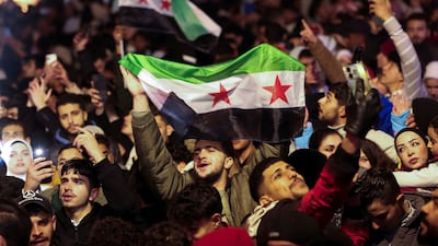 People gather during New Year's celebrations in Damascus yesterday. A national dialogue conference planned for the weekend is a chance to build on the progress made so far. Reuters