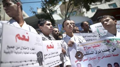 Visually impaired Palestinian youths hold placards during a demonstration outside the Red Crescent offices in Gaza City to protest the arrest of their karate teacher who was detained by Israeli authorities on his way back from the West Bank. Mahmud Hams / AFP