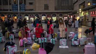 People wait outside the Beijing railway station. AFP