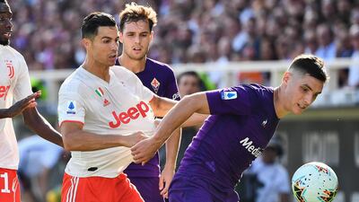 Fiorentina's Serbian defender Nikola Milenkovic holds off Juventus' Portuguese forward Cristiano Ronaldo. AFP