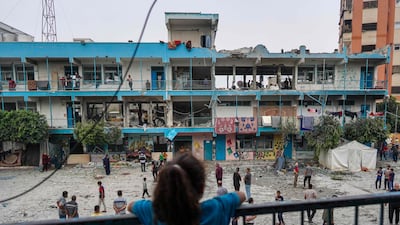 A Palestinian girl looks at a UN school housing displaced people that was hit during Israeli bombardment of Nuseirat, in central Gaza. AFP