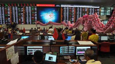 Dragon and lion dancers perform at the trading floor of the Philippine Stock Exchange to start the first day of trading for the Lunar New Year. Jay Directo / AFP
