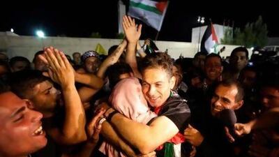 A freed Palestinian prisoner hugs a relative after his arrival in the West Bank city of Ramallah. Israel freed 26 prisoners yesterday as part of a US-brokered deal to revive peace talks.