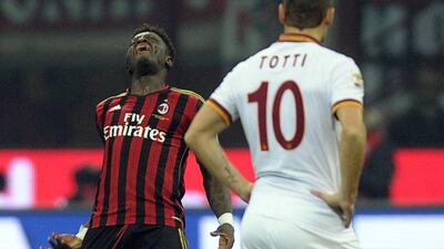 Sulley Muntari, left, reacts after scoring a late equaliser for Milan on Monday as Roma's Francesco Totti, right, looks on. Daniele Mascolo / EPA