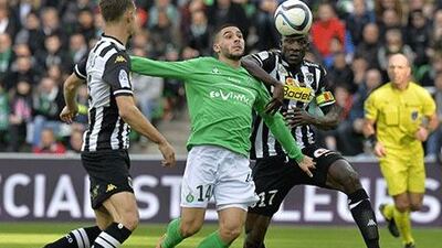Saint-Etienne's French forward Neal Maupay, centre, vies with Angers' Senegalese midfielder Cheikh N'Doye, right, during their Ligue 1 game late on Sunday. Jean-Philippe Ksiazek / AFP