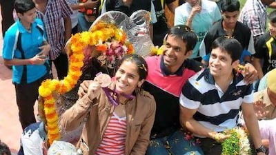 Indian badminton player Saina Nehwal (left) became the first Indian badminton player to earn an Olympic medal when world number one Wang Xin retired in tears from their bronze medal play-off.