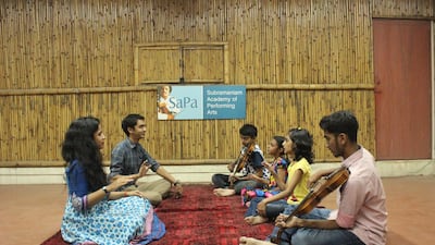 Ambi and Bindu Subramaniam, left Photos SaPaBindu and Ambi with kids at the academy