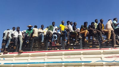 People displaced by the war in Sudan travel on a lorry in Al Jazirah state on December 16. The uprooting of whole communities acts as a driver for irregular migration and presents serious challenges for Africa's more fragile economies. AFP