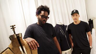 Dao-Yi Chow, right, and Maxwell Osborne, the designers behind Public School, pose for a portrait in their New York fashion studio. AP