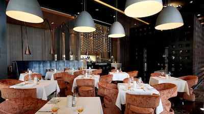 Eclectic lighting and floor-to-ceiling copper dividers dominate the decor at The Foundry at the Southern Sun hotel in Abu Dhabi. Pawan Singh / The National