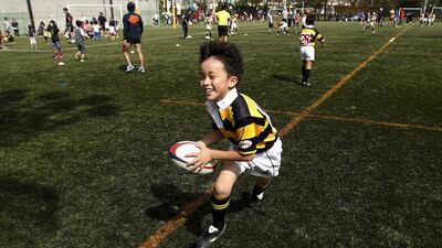A member of Katsushika Rugby School runs with a ball during a class this month in Tokyo. Yuya Shino / Reuters